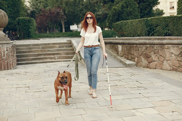 Guide dog helping blind woman in park