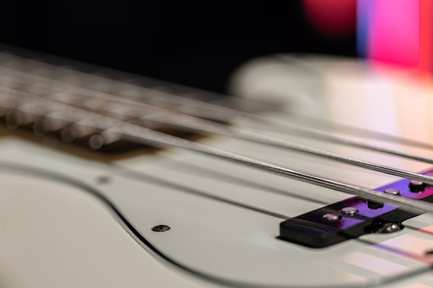 Guitar bass string details, close up of the iron strings on blurred background.