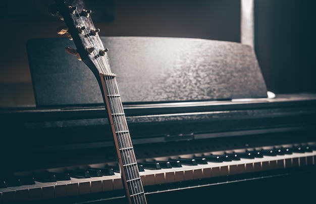 Free Photo guitar and electronic piano in a dark room closeup