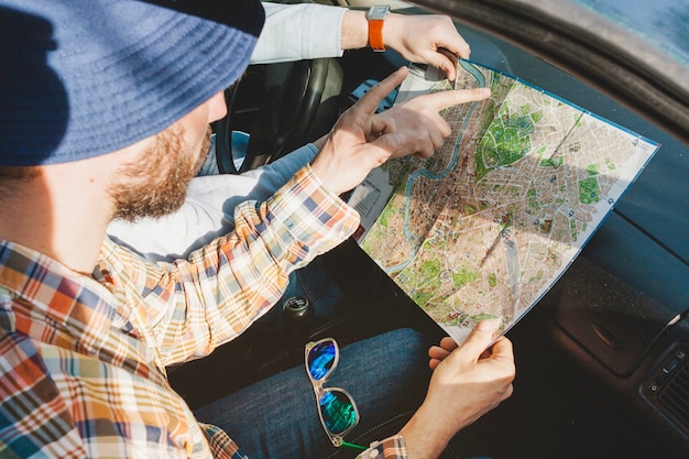 Guy in car with map