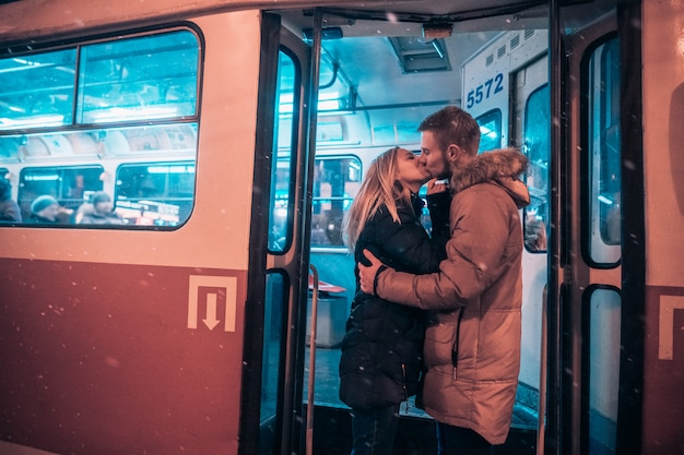 The guy and the girl kiss on the tram