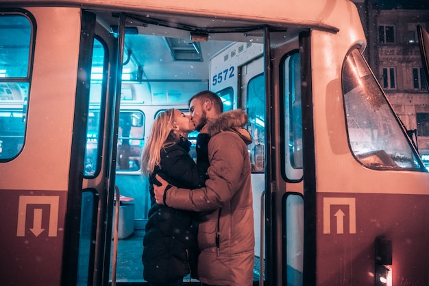 The guy and the girl kiss on the tram