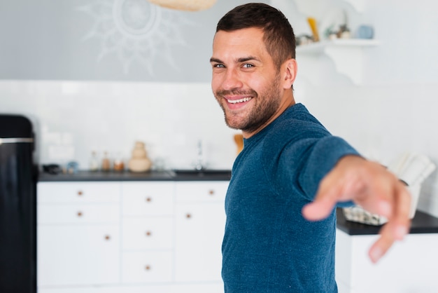 Guy looking at camera and stretching an arm