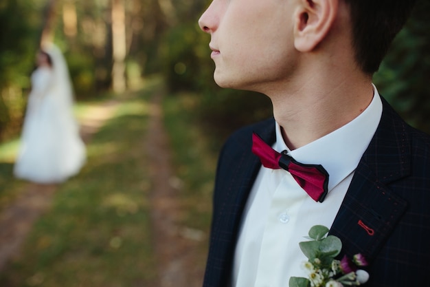 Free Photo guy in tuxedo looking away standing outside