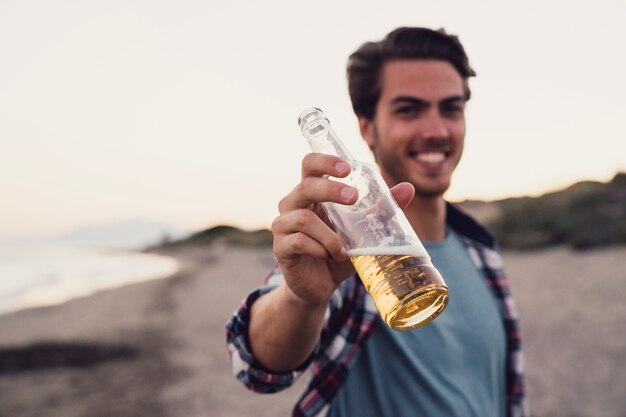 Guy with bottle of beer at the beach