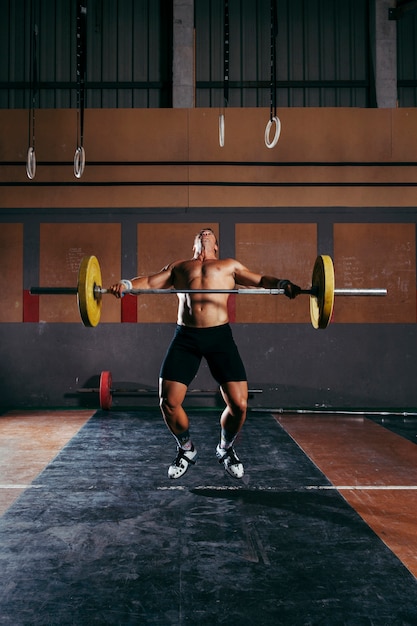 Gym concept with man lifting barbell