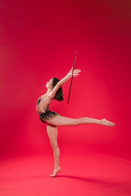 Gymnast making positions with the hoop