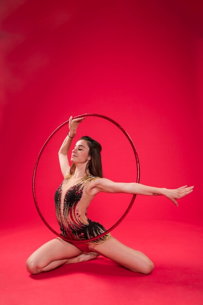 Gymnast making positions with the hoop