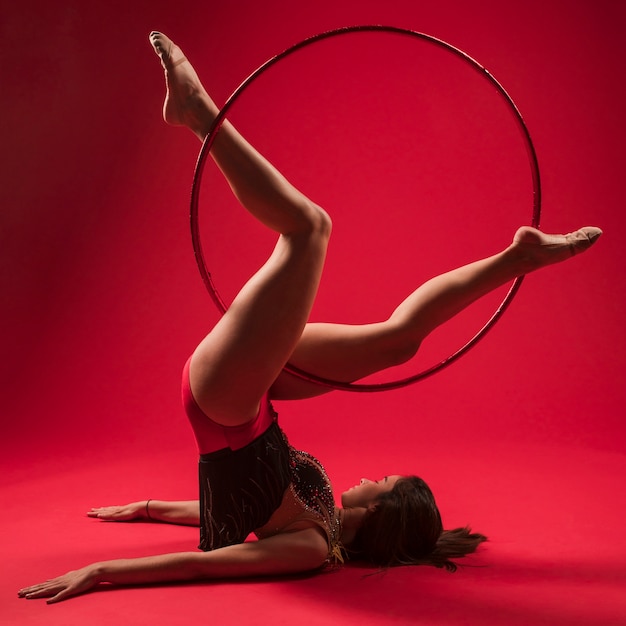 Gymnast making positions with the hoop