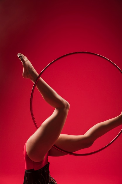 Gymnast making positions with the hoop