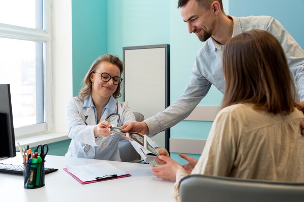 Gynecologist evaluating pregnancy with patient