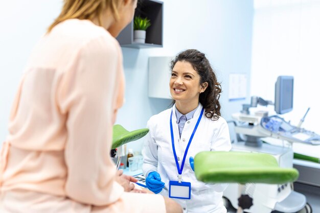 Gynecologist talking with young female patient during medical consultation in modern clinic Patient with a gynecologist during the consultation in the gynecological office