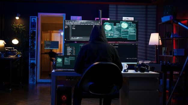 Hacker arriving in secret base with laptop ready to start programming viruses