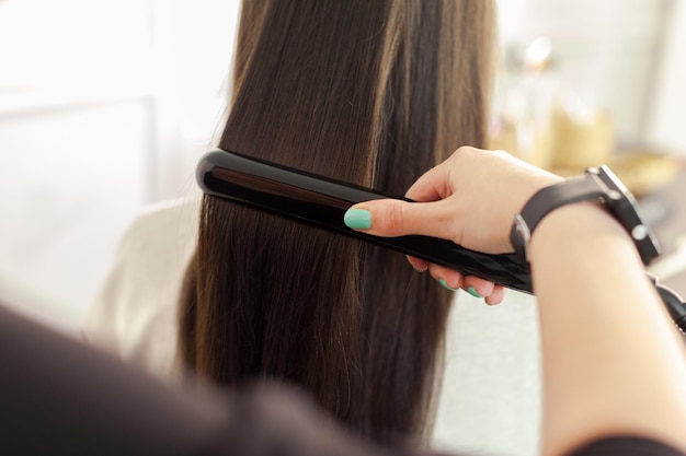 Free photo hairdresser does hair style of woman