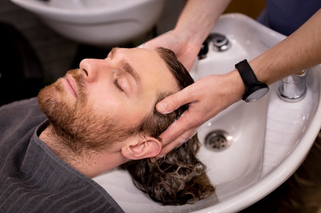 Free photo hairdresser grooming their client