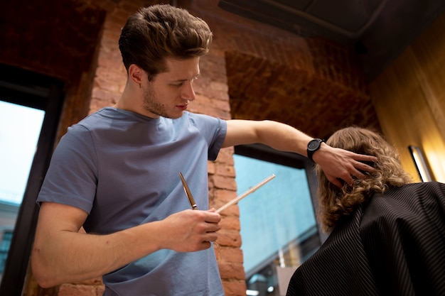 Free photo hairdresser grooming their client