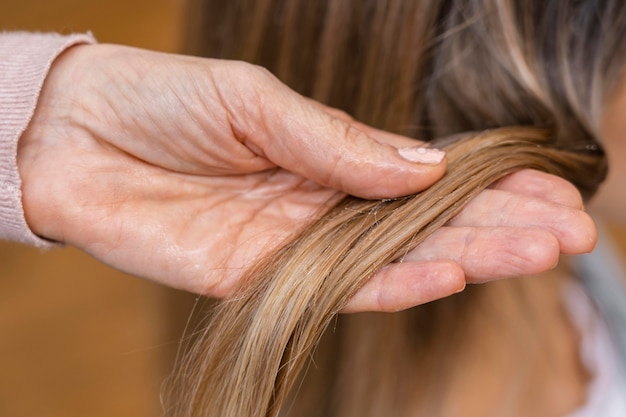 Hairdresser holding tuft of hair