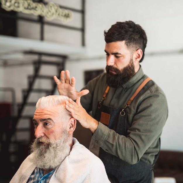 Free photo hairdresser preparing customers hair for haircut