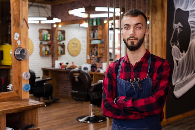 Hairdresser in red shirt looking at camera