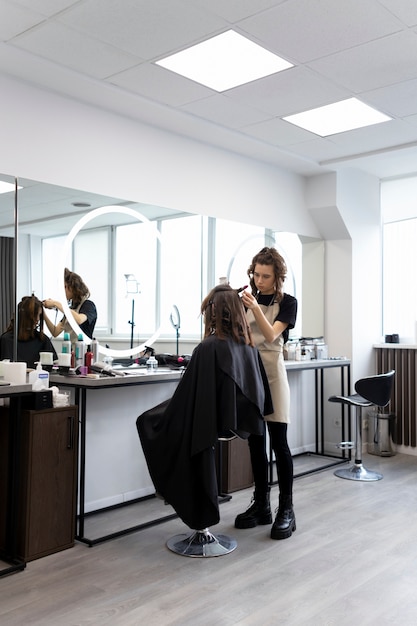 Hairdresser taking care of her client