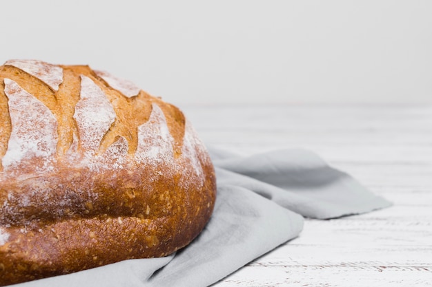 Half of bread on kitchen cloth