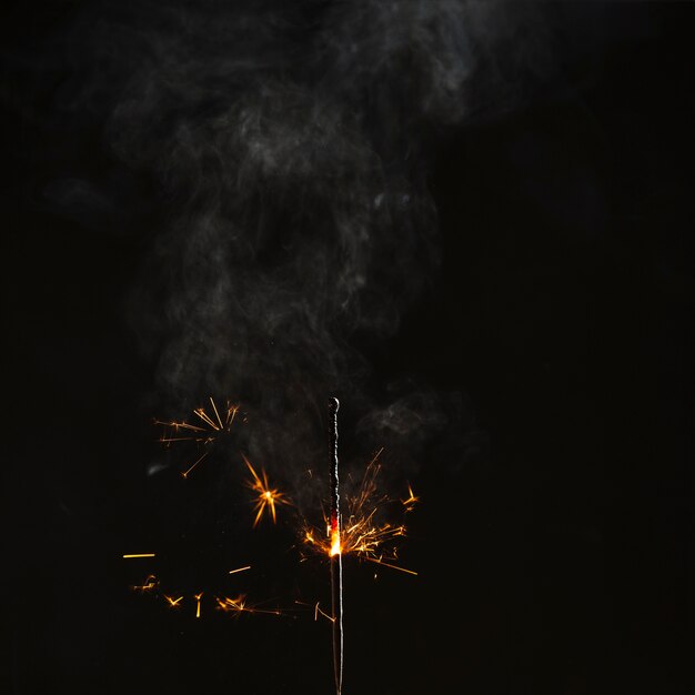 Half-burnt sparkler with bright sparks