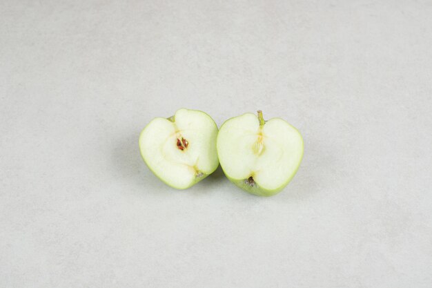 Half cut fresh apples on gray surface