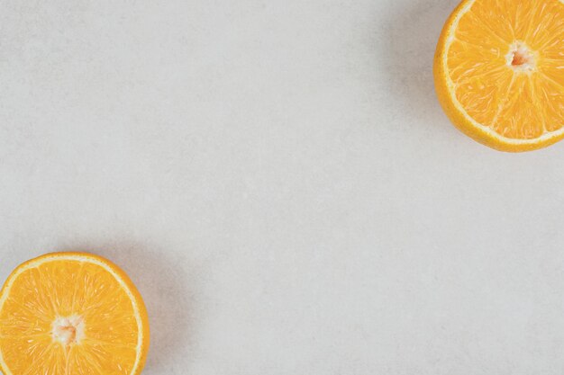 Half cut juicy orange on gray surface