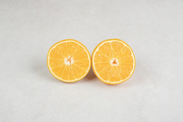 Half cut juicy orange on gray surface