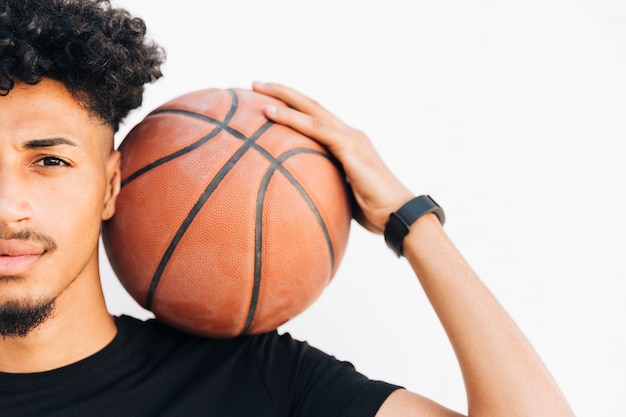 Half face of black man with basketball