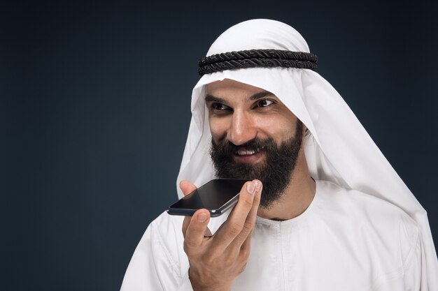 Free Photo half-length portrait of arabian man on dark blue studio