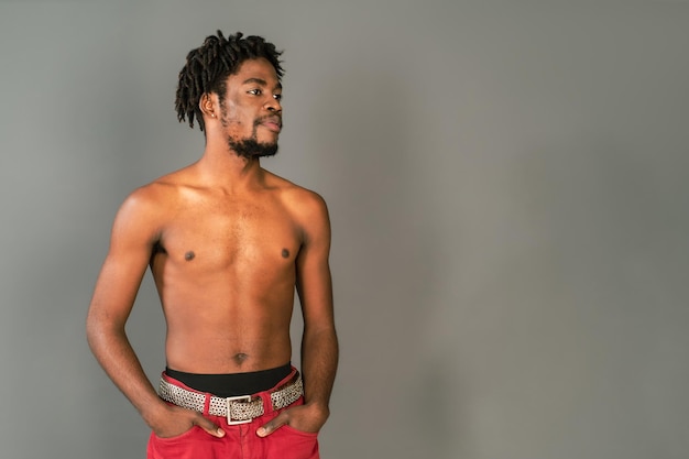 Half naked african american man posing on camera isolated on grey background Topless african american man