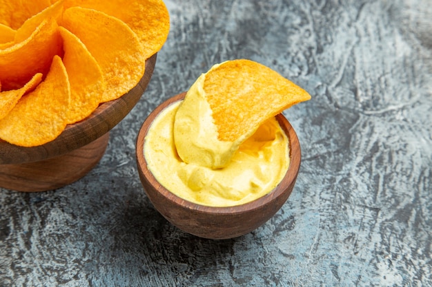 Half shot of delicious homemade potato chips mayonnaise on gray table