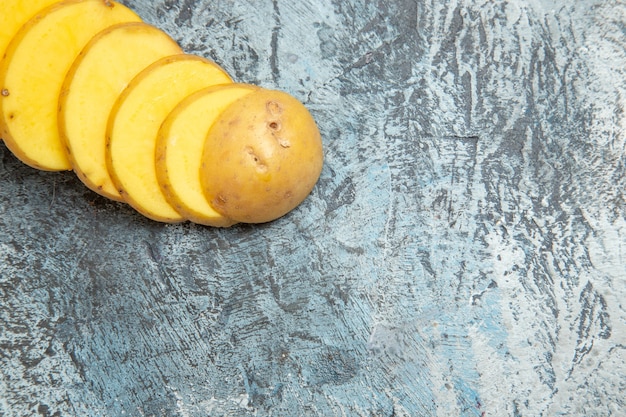 Half shot of easy delicious unpeeled potato slices on gray table