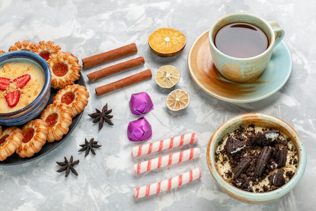 Half-top view cup of tea with chocolate cookie dessert and jam cookies on light-white desk cookie chocolate cake bake pie sugar sweet