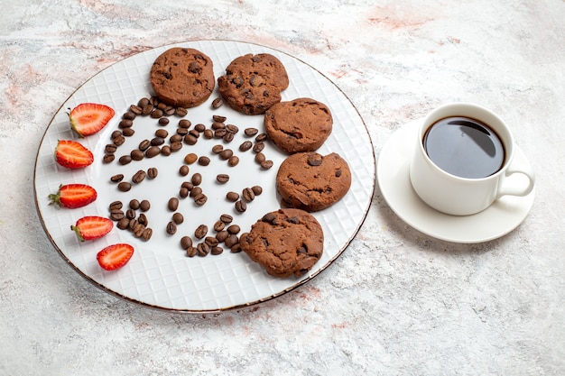 Half-top view delicious chocolate cookies with chocolate chips and strawberries on the white surface biscuit sugar sweet bake cake cookies