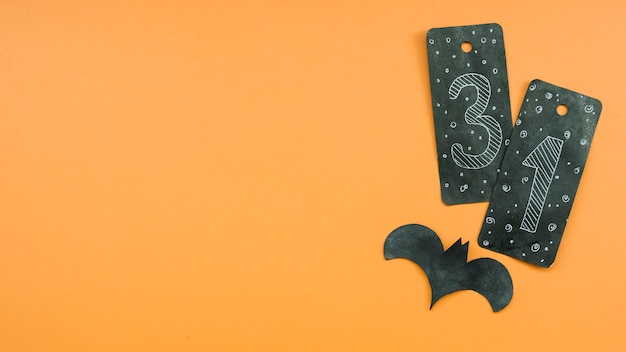 Halloween composition with black card with number thirty-one and bat