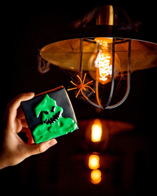 Halloween cookies on a background of a bright light bulb