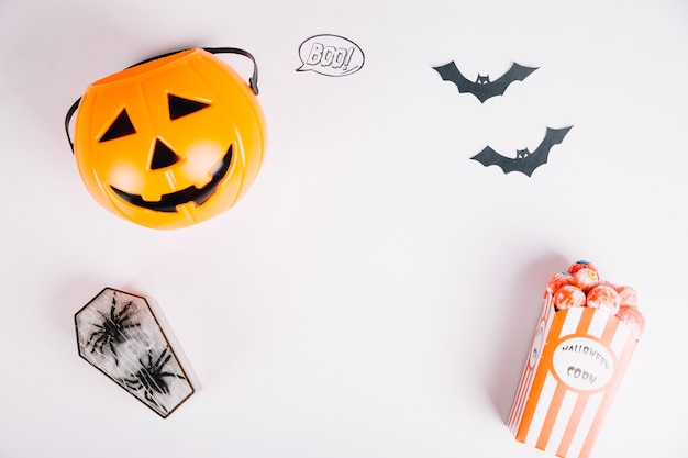 Halloween decorations and treats on white surface