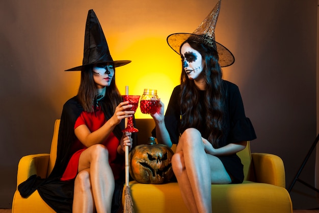 Halloween girls on couch with drinks