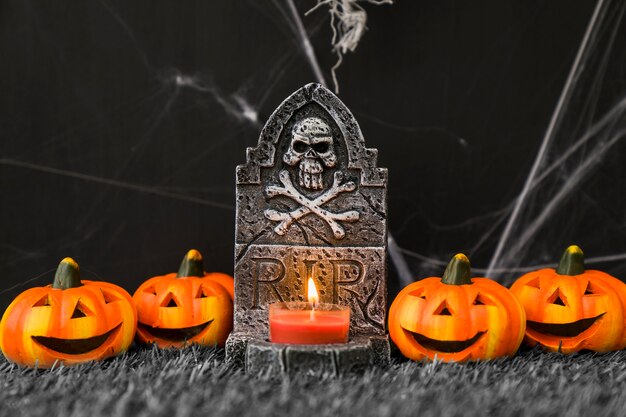 Halloween graveyard decoration with smiling pumpkins