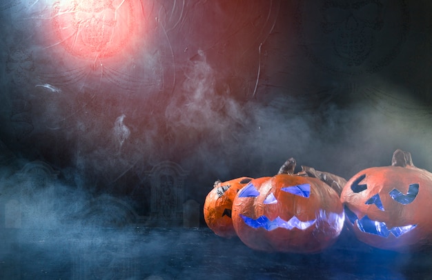 Halloween handmade pumpkins illuminated inside lying on side with smoke