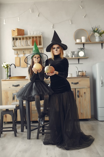 Free Photo halloween. mother and daughter in halloween costume. family at home.