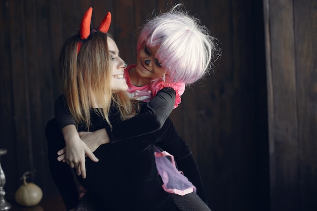 Free photo halloween. mother and daughter in halloween costume. family at home.