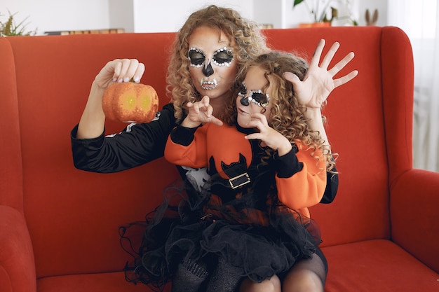 Free photo halloween. mother and daughter in mexican style halloween costume. family at home.