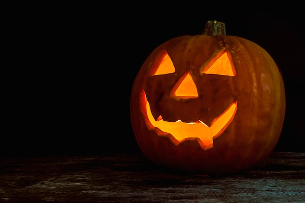 Free Photo halloween pumpkin head jack lantern on wooden background