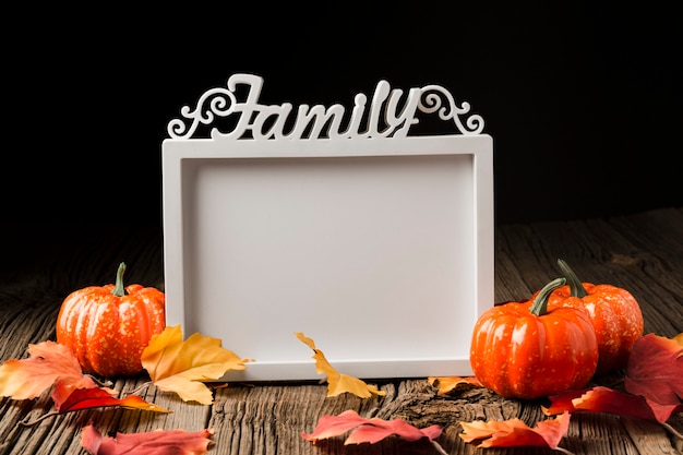 Halloween pumpkins with leaves and mock-up frame