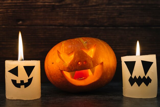 Halloween spooky carved pumpkin with candles