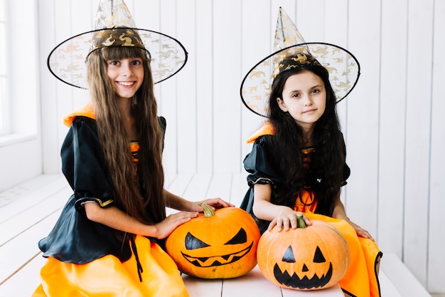 Free Photo halloween witches with spooky pumpkin on celebration