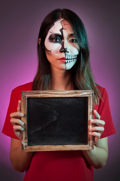 Halloween woman holding slate